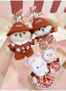 Close-up detail of cute chocolate series plush animal keychains with hats and plaid outfits.