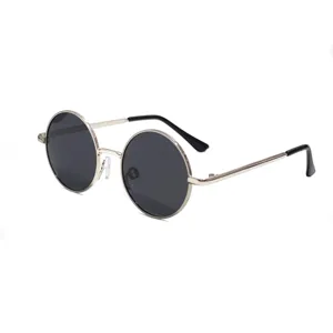 Close-up detail of classic round metal frame sunglasses with dark lenses and protective tips.