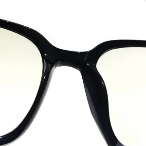 Close-up detail of black eyeglasses frame bridge, showing smooth texture and sturdy structure.