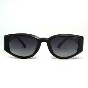 Detailed closeup of stylish black chunky frame retro sunglasses with gradient lenses.