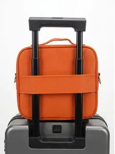 Orange travel cosmetic bag with trolley sleeve and handle, portable makeup case for travel.