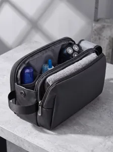 Detailed view of dark grey travel toiletry bag with multiple compartments for packing.