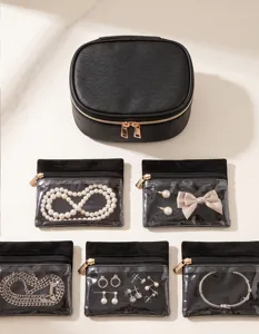 Black travel jewelry organizer set with transparent pouches for earrings and necklaces.