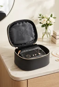 Portable black jewelry cosmetic bag organizer with transparent compartments for travel use.