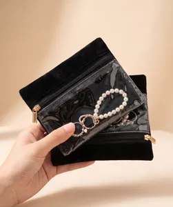 Detail view of black velvet clear PVC zipper pouch showcasing jewelry storage functionality.