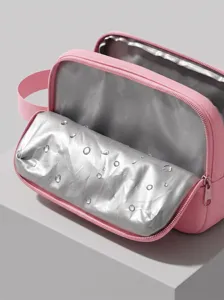 Pink waterproof cosmetic bag detail showing silver lining and smooth zipper closure.