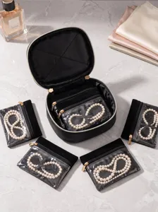 Portable black travel jewelry organizer bag set with clear window cosmetic pouches.