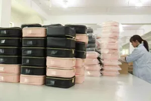 Detailed view of large capacity waterproof travel makeup organizer bag in black and pink colors.