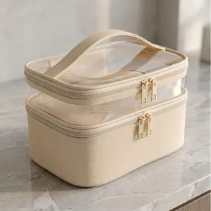 Transparante dubbellaagse cosmetische tas met handvat en gouden ritsen voor reizen.