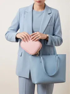 Detailed view of the pink cosmetic travel bag and blue tote set, elegant and portable.