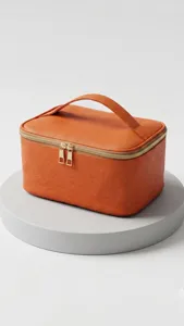 Large capacity orange travel cosmetic bag detail view, portable makeup case with gold zipper.
