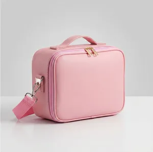 Pink PU leather cosmetic bag with shoulder strap, travel makeup storage case detail view.