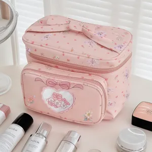 Pink floral cosmetic bag large capacity portable travel makeup organizer with cute bow design.