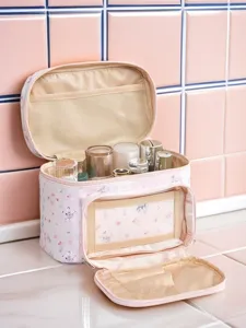 Detailed view of pink floral makeup storage bag interior with mesh pockets and cosmetic bottles inside.