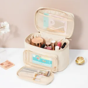 Beige large capacity waterproof travel makeup bag with brush holder and multi compartments.