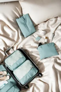 Detail view of lifestyle travel packing cubes set in soft green, perfect for organizing clothes.