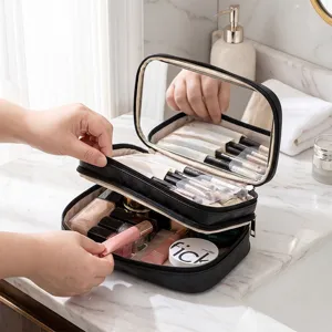 Sac de maquillage noir portable multicouche avec miroir et porte-pinceaux pour voyages.