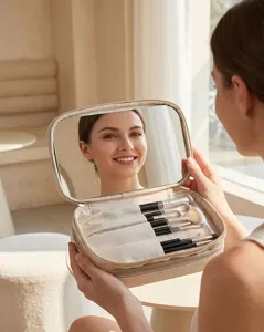 Sac de maquillage portable avec miroir intégré et étui à pinceaux pour cosmétiques.