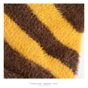 Cute striped fuzzy knit hat detail, brown and yellow fluffy texture for autumn and winter warmth.