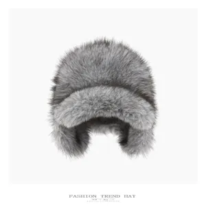 Close up of a winter gray faux fur trapper hat with fluffy earflaps and a warm brim.