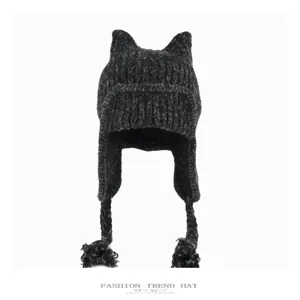 Close-up detail of the dark grey knitted cat ear hat showing soft texture and braids.