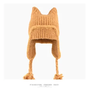 Brown knitted cat ear trapper hat detail, winter warm plush fluffy earflap fleece beanie.
