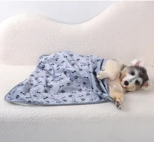 Cozy soft pet blanket with cute paw prints for dogs and cats, warm winter sleeping mat for pets.