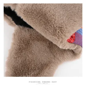 Close-up detail of winter plush trapper hat with colorful plaid lining and warm ear flaps.