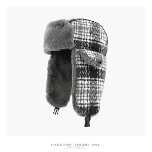 Close-up detail of the black and white plaid trapper hat featuring soft grey plush lining.