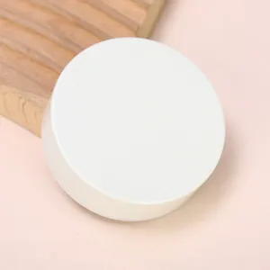 Detailed view of the white minimalist pocket cup cap, compact and portable design.