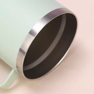 Stainless steel 30oz tumbler close-up detail, vacuum insulated travel mug with handle mint green
