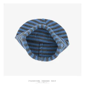 Close-up view of the blue and grey striped knitted slouchy beanie interior and fabric detail.