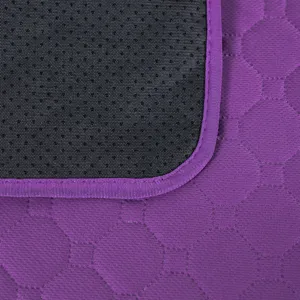 Washable reusable pet pee pad with purple quilted fabric and black non-slip waterproof backing.