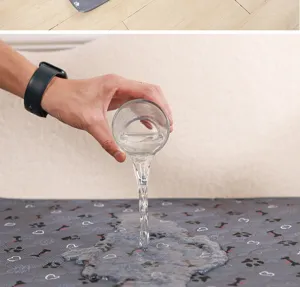 Close-up detail of absorbent pet pee pad showing instant water absorption and waterproof design.