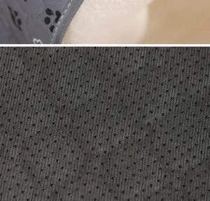 Pet pee pad detail view showing anti-slip dot backing and soft absorbent fabric texture.