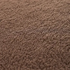 Tapis pour animaux en polaire marron gros plan texture de tissu, doux et chaud pour chien.