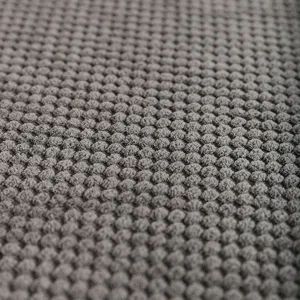 Grey bubble fleece pet mat fabric close-up, soft texture for warm dog sleeping bedding.