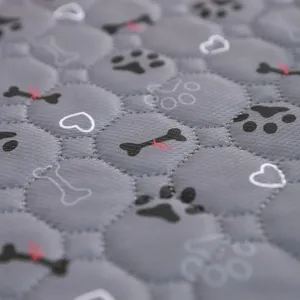 Washable reusable pet pee pad with cute bone and paw print design for dogs daily use.