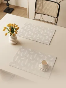Detailed view of wabi-sabi cream leather placemat on dining table with elegant geometric arches.
