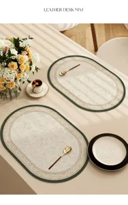Detailed view of vintage oval leather placemat with green border and classic pattern for table.