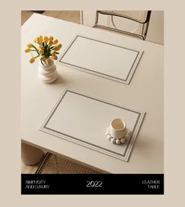 Close-up detail of luxury leather placemat and matching coaster on clean minimalist dining table.