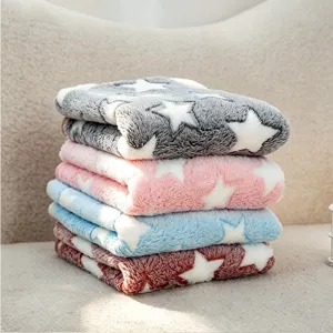 Detailed close-up shot of cozy flannel pet blanket with white star pattern design.