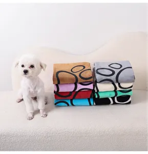 Detailed scene of soft coral fleece pet pee pads with cute claw print design in multiple colors.