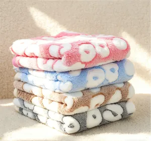 Fluffy flannel pet blanket with embossed paw print design, warm and cozy dog cat mat for winter.