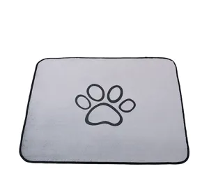 Grey pet pee mat detail showing soft coral fleece texture and cute black paw print pattern.