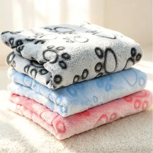 Soft flannel pet blanket detail, cute paw print pattern, cozy sleeping mat for dogs and cats.