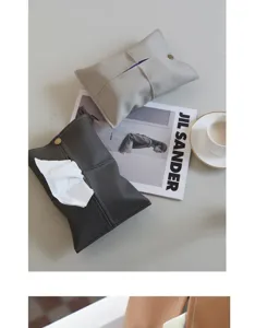 Detailed shot of stylish leather car tissue box set on table with modern decor aesthetic.