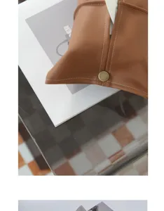 Close-up detail of luxury soft leather car tissue box with snap button design for home and auto.