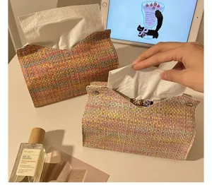 Detailed view of the colorful woven tissue box on a cozy desk, highlighting texture and snap buttons.