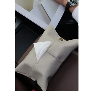 Detailed view of beige leather car tissue box, stylish interior accessory for armrest.